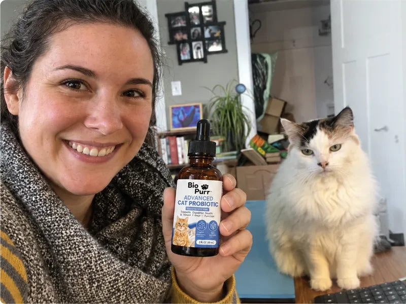 Jenna R. with her cat and a bottle of Biopurr