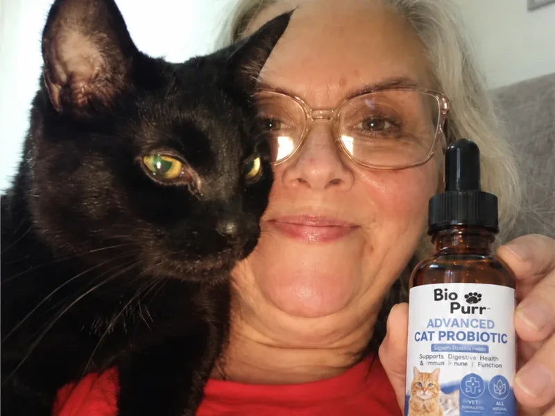 Hannah B. with her cat and a bottle of Biopurr
